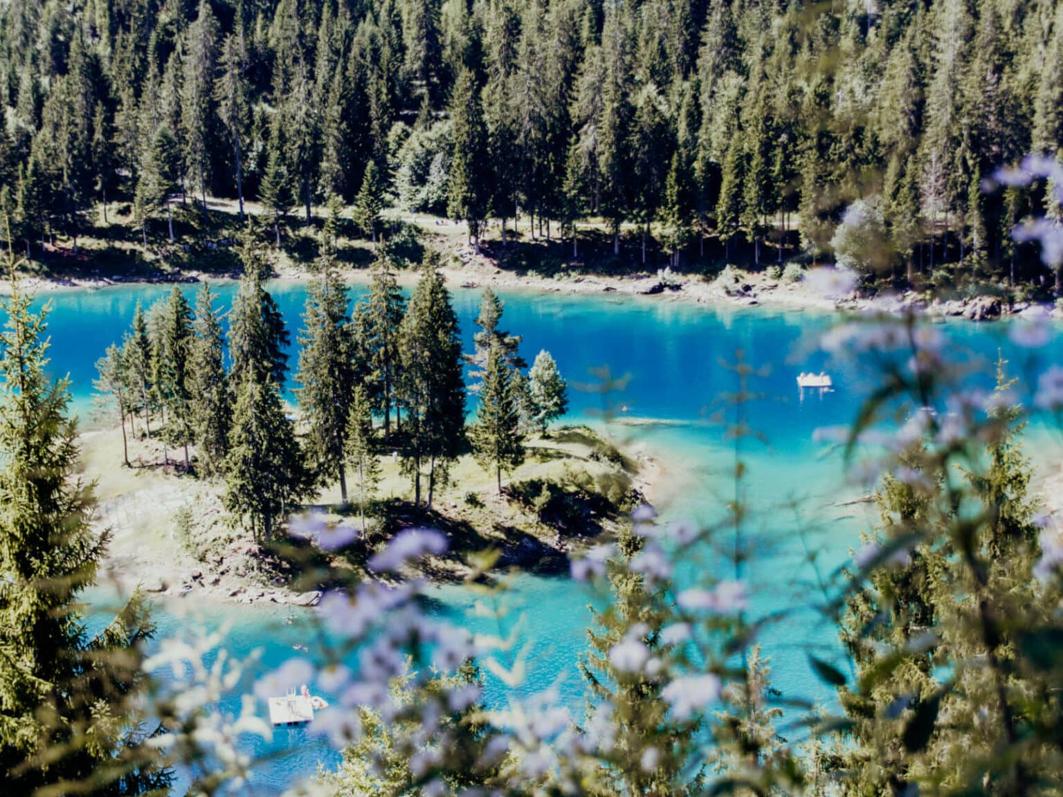 Caumasee, ein türkisblauer Bergsee in der Schweiz mit kleinen Inseln und Nadelbäumen drum herum