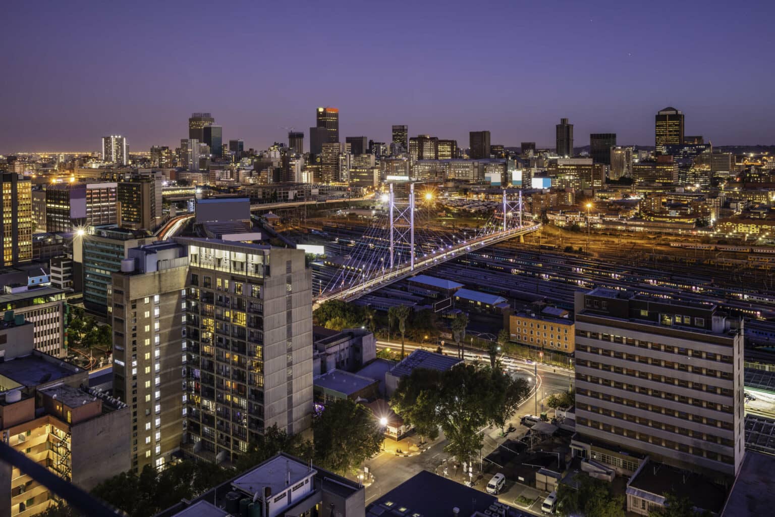 Ein Lichtermeer bei Nacht: Johannesburg mit der bekannten Nelson-Mandela-Brücke.
