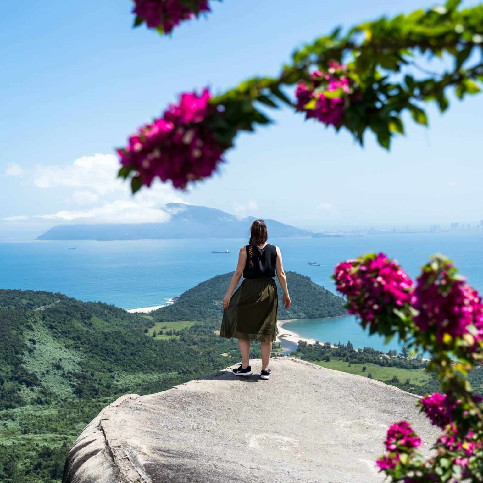 Biggi auf einem Felsen mit Blick auf das Meer am Wolkenpass.