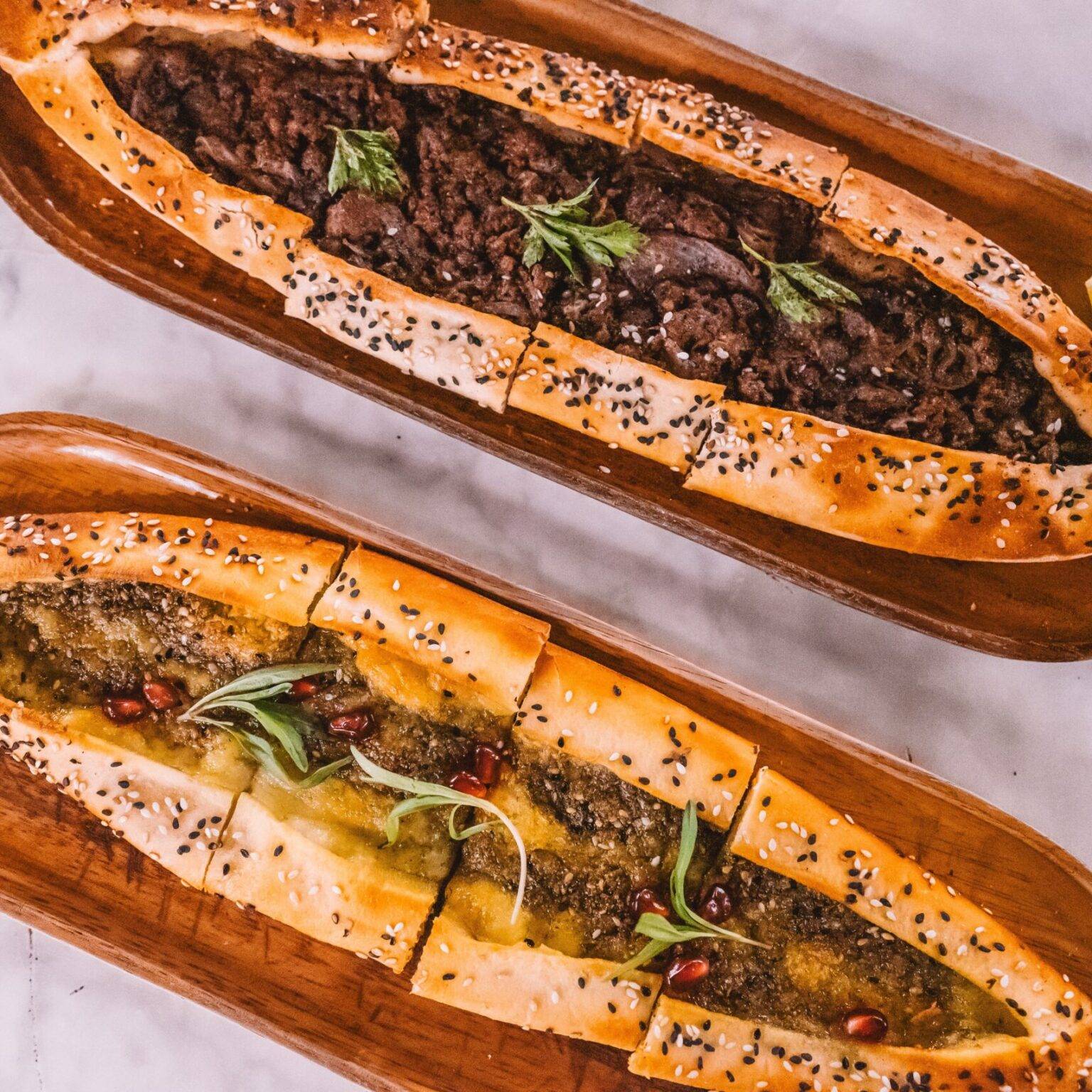 Zwei Pide, eine mit Gemüse und eine mit Fleisch gefüllt.