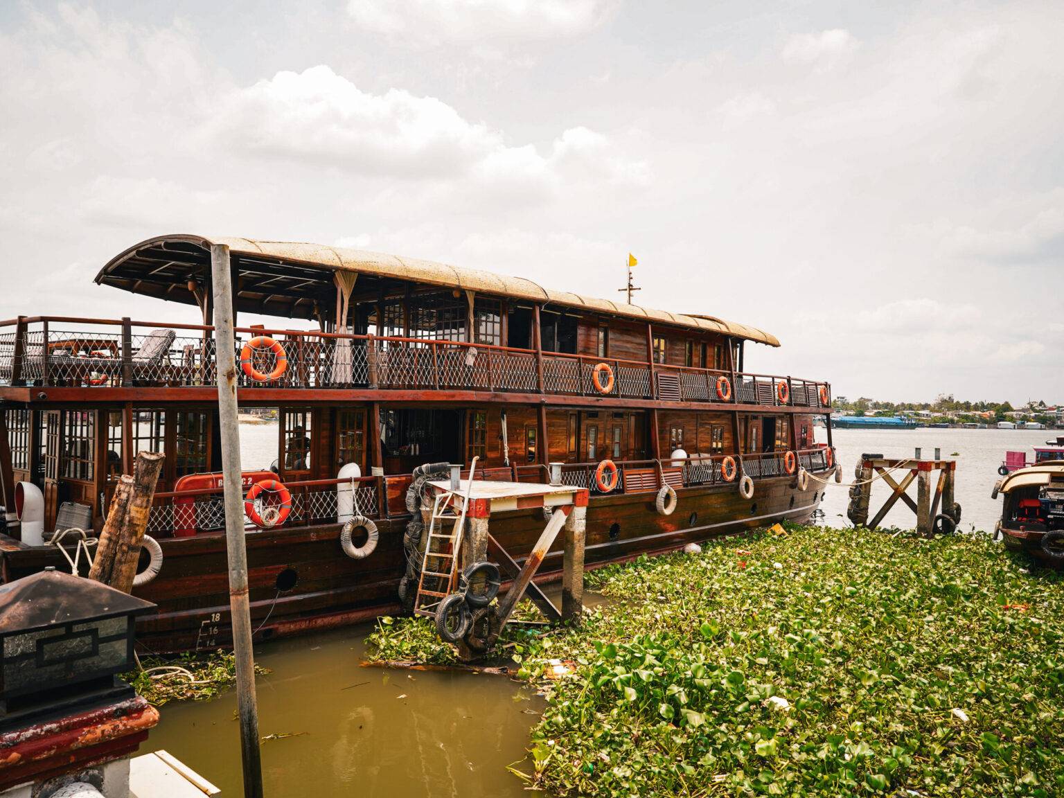 Die Basaac 2, ein großes hölzernes Flusskreuzfahrtschiff auf dem Wasser.