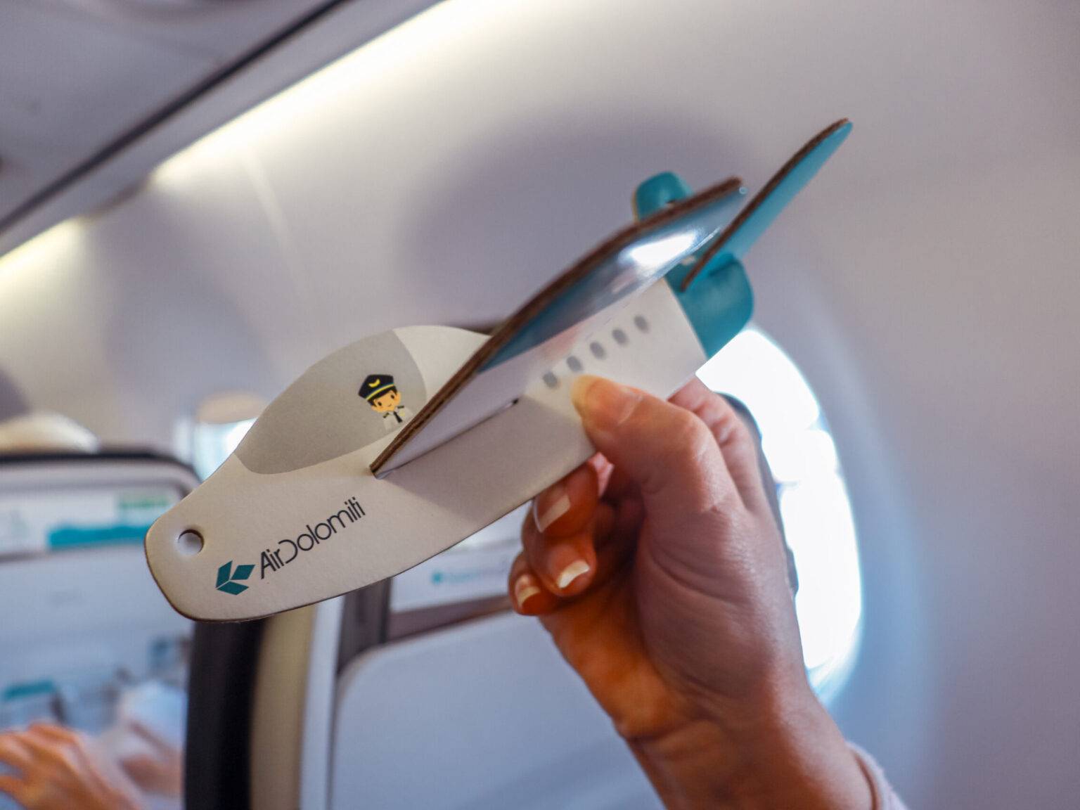 Ein Pappflieger von Air Dolomiti als Beschäftigung für das Kind im Flugzeug.