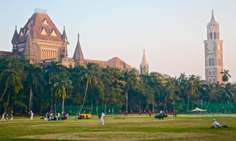 Am Oval Maidan in Fort wird Cricket gespielt, im Hintergrund alte Kolonialgebäude.