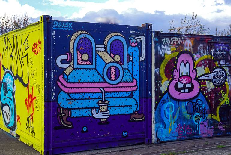 In der NDSM-Werft in Amsterdam stehen mit Graffiti besprühte Container.