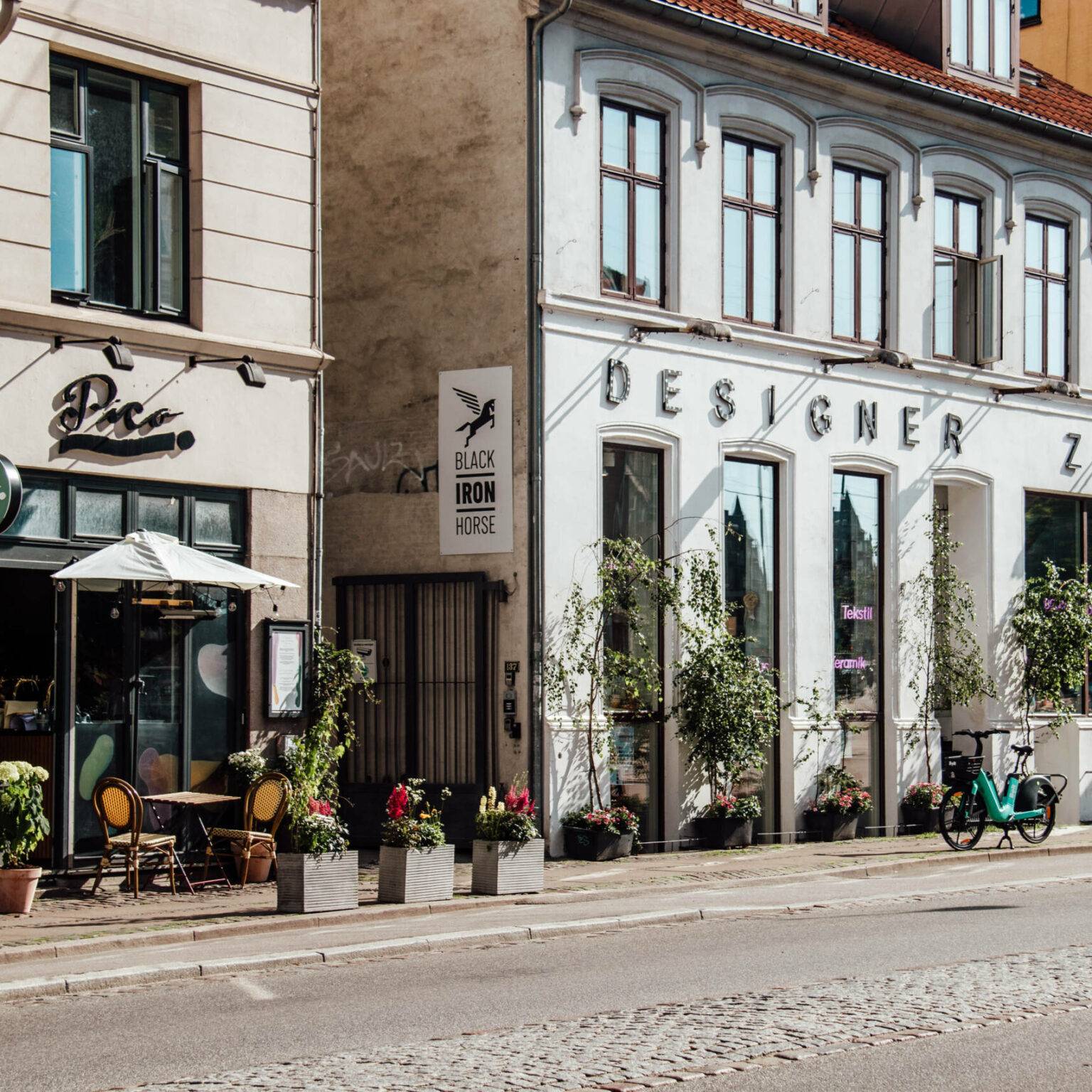 In den Straßen des angesagten Kopenhagener Viertels Vesterbro reihen sich coole Restaurant und Cafés mit blumenverzierten Außenbereichen aneinander.