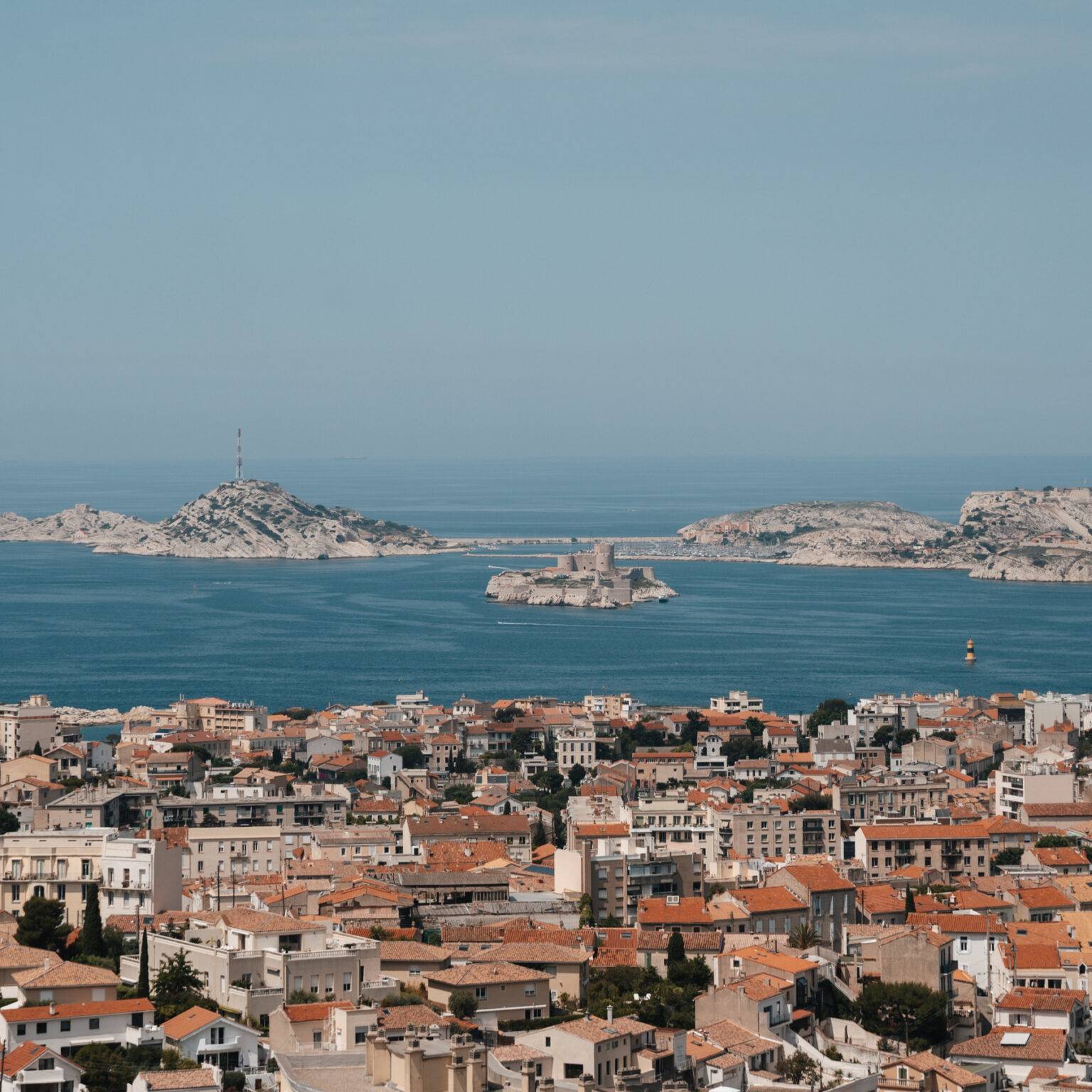 Ausblick über die Dächer von Marseille, im Hintergrund das Meer.
