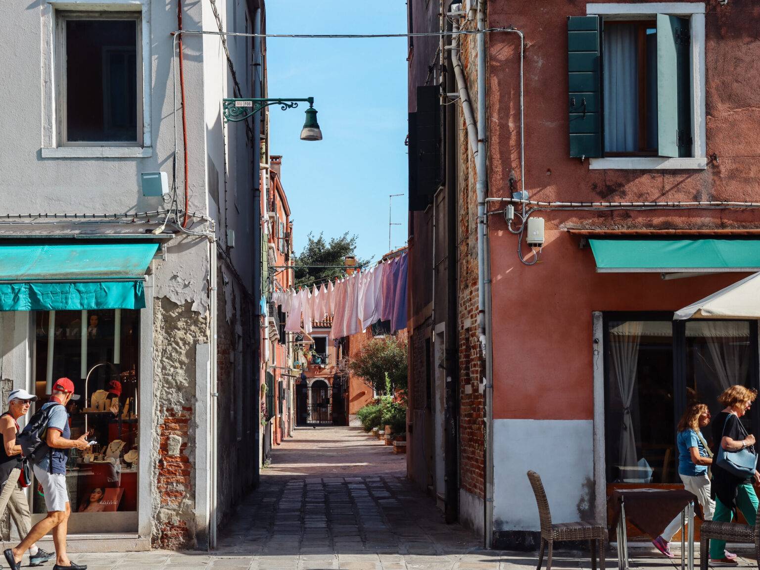 Eine kleine Gasse in Murano, die in einen Hinterhof mit Wäscheleine führt.