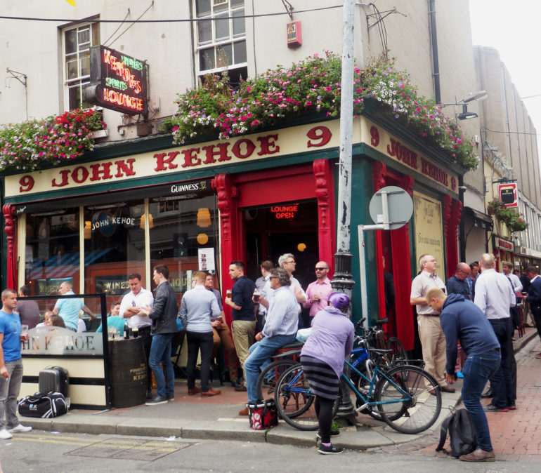 Vor dem Pub John Kehoe in Dublin haben sich bereits einige Gäste mit einem Guiness in der Hand eingefunden.