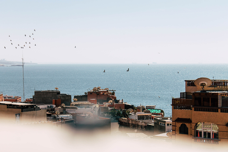 Above the roofs of Taghazout in Morocco you have a beautiful view of the sea.