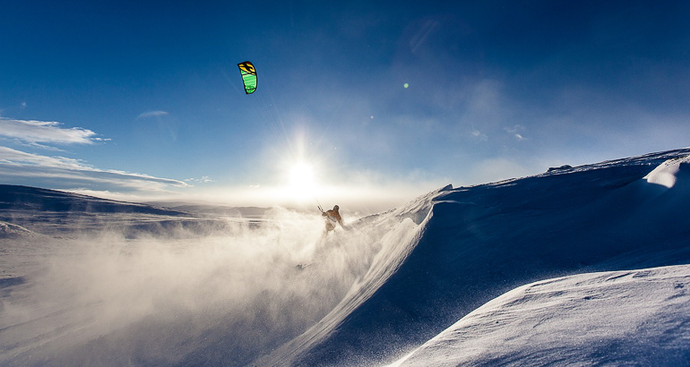 Für einen perfekten Winterurlaub bietet sich in den verschneiten Bergen von Norwegen Snowkiting an.