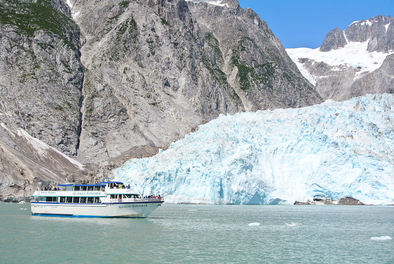 A sightseeing boat cruises the waters off the Kenai Glacier in Alaska, USA.