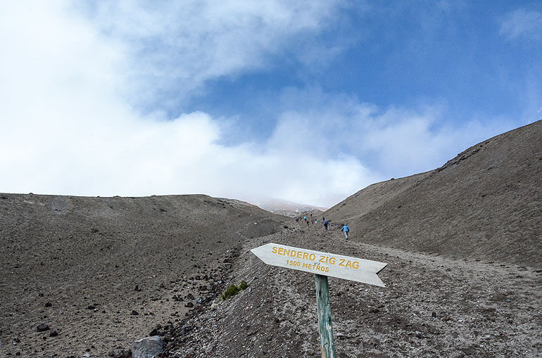 Climbing a volcano with gasping breath: through lava and sand we climb the Cotopaxi.