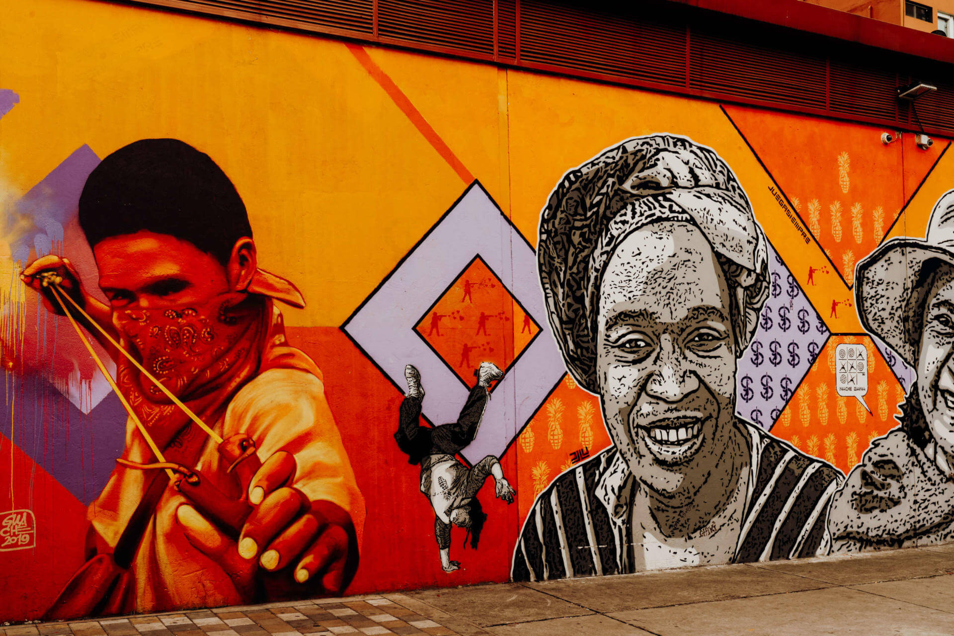 On the Bogotá Graffiti Tour you will learn a lot about the indigenous peoples of Colombia. Graffiti wall with faces on it.
