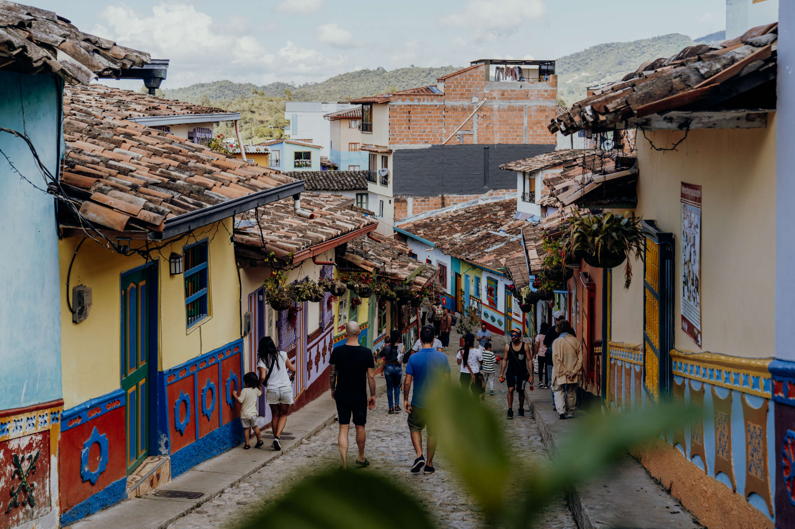 Guatapé - the most colorful city in Colombia. An alley with colorful houses in which people walk.