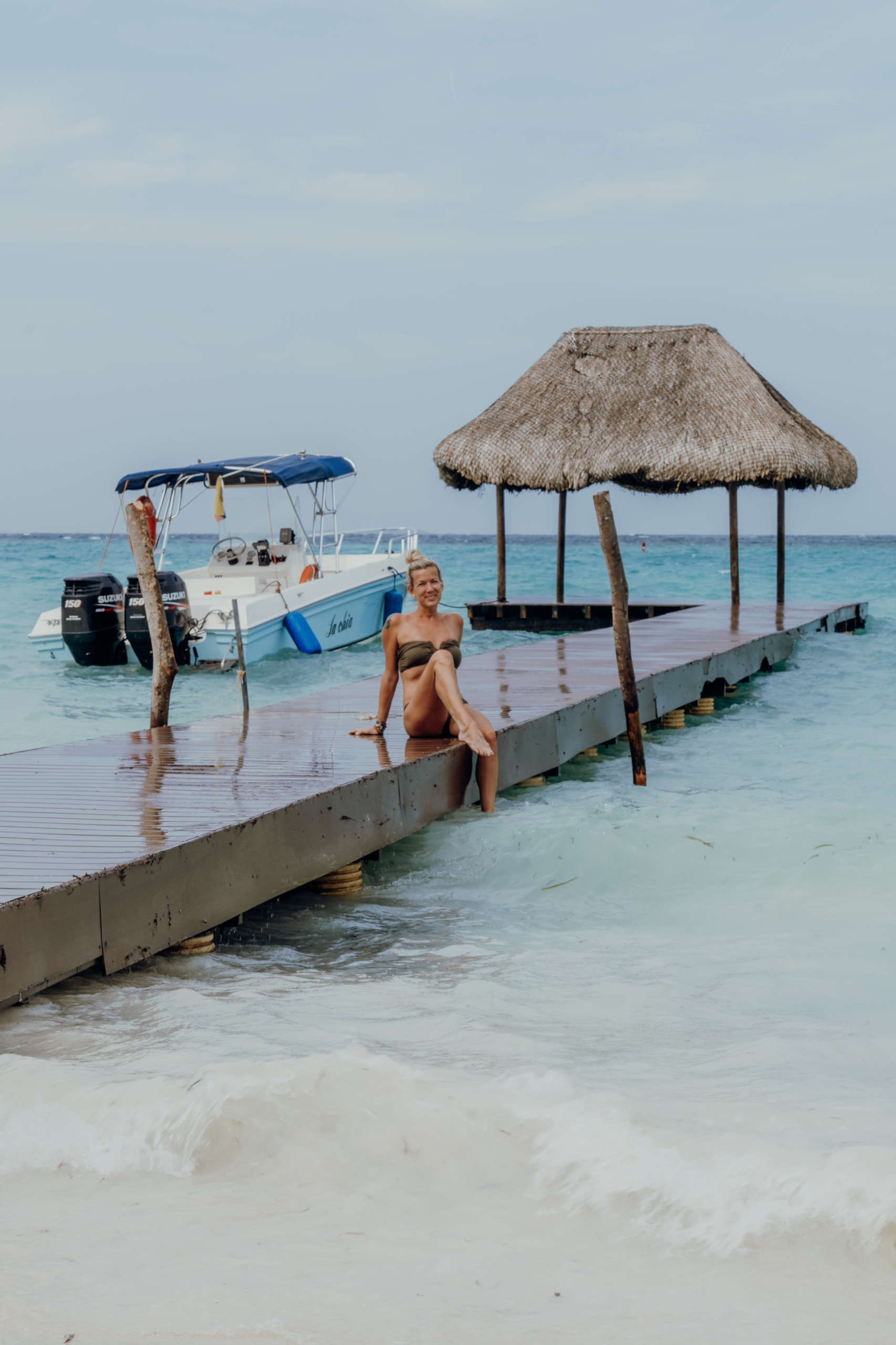 A relaxing afternoon at Playa Libre. A woman sitting on a jetty.