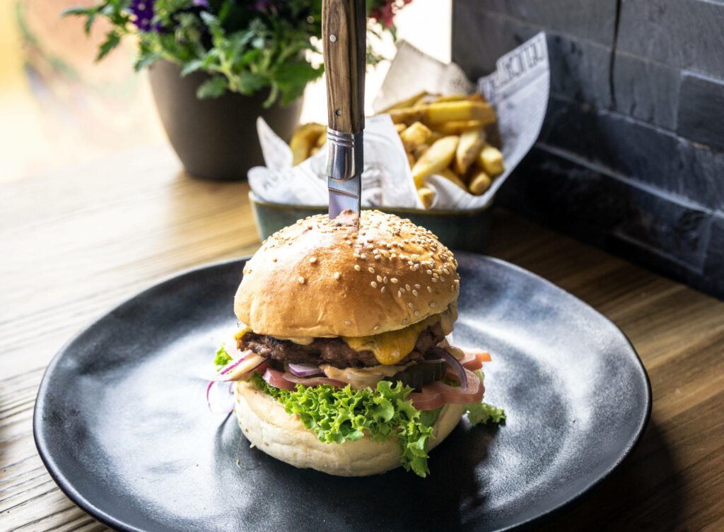 Gute Burger, die hochgestapelt und aufgespießt im Restaurant serviert werden, findet man auch in Amsterdam.