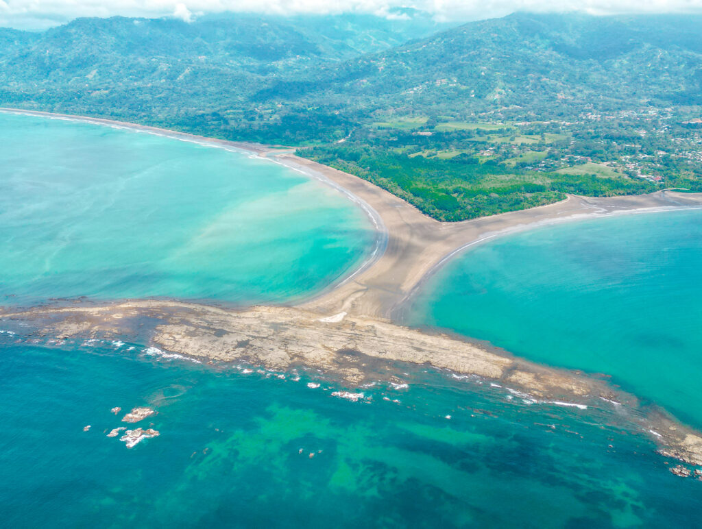 Aerial view of whale tail beach in Ballena Marine National Park with turquoise sea.