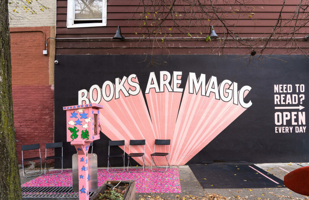 The words "Books are Magic" graffitied on a wall in Brooklyn.