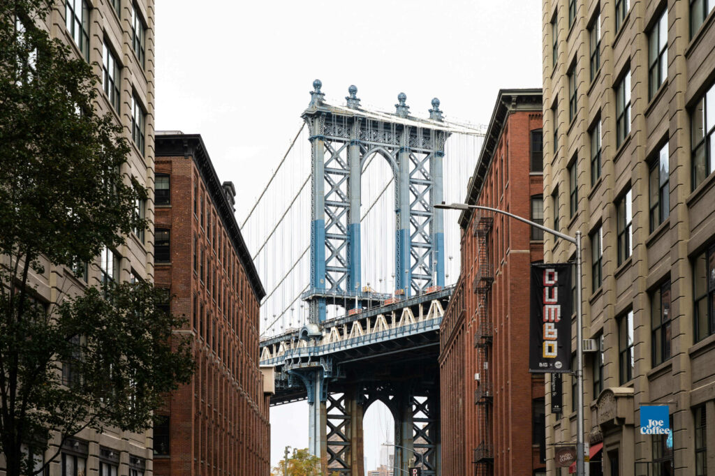 Looking through houses onto the Manhattan Bridge from the Washington Street Viewpoint in Dumbo, a neighborhood in the New York borough of Brooklyn.