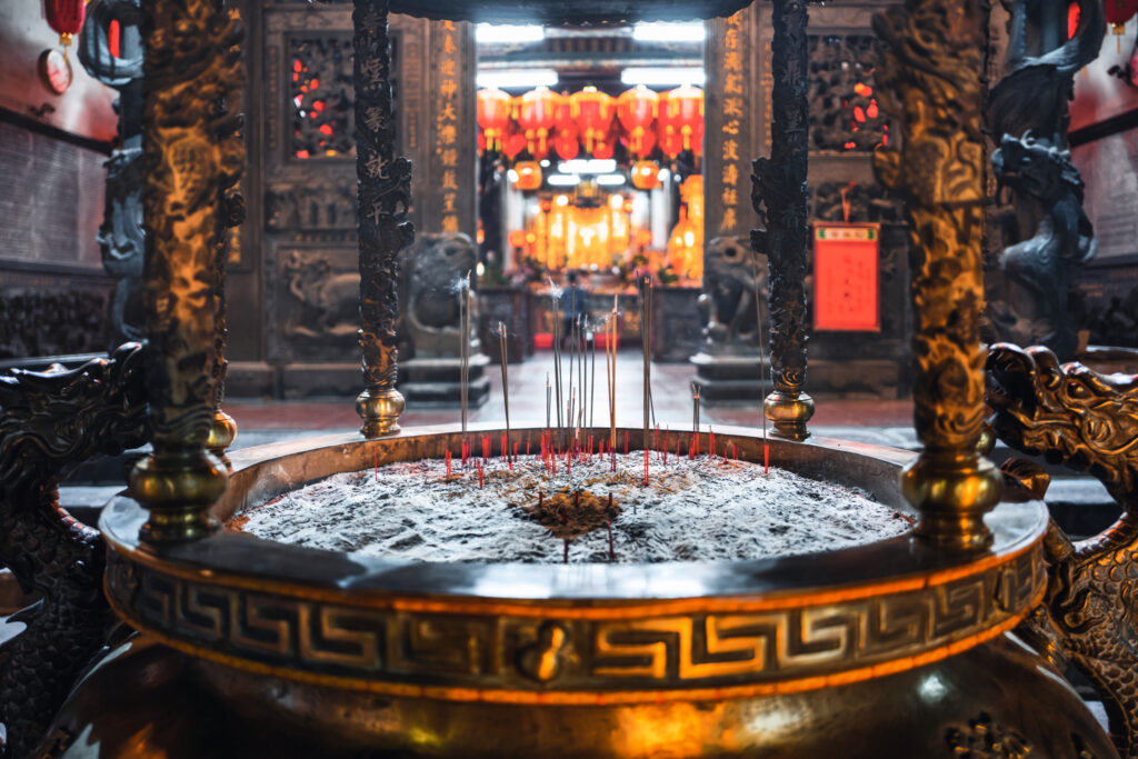 Weihrauchstäbchen in einem Prunkvollen Gefäß im Longshan Tempel in Taipeh.